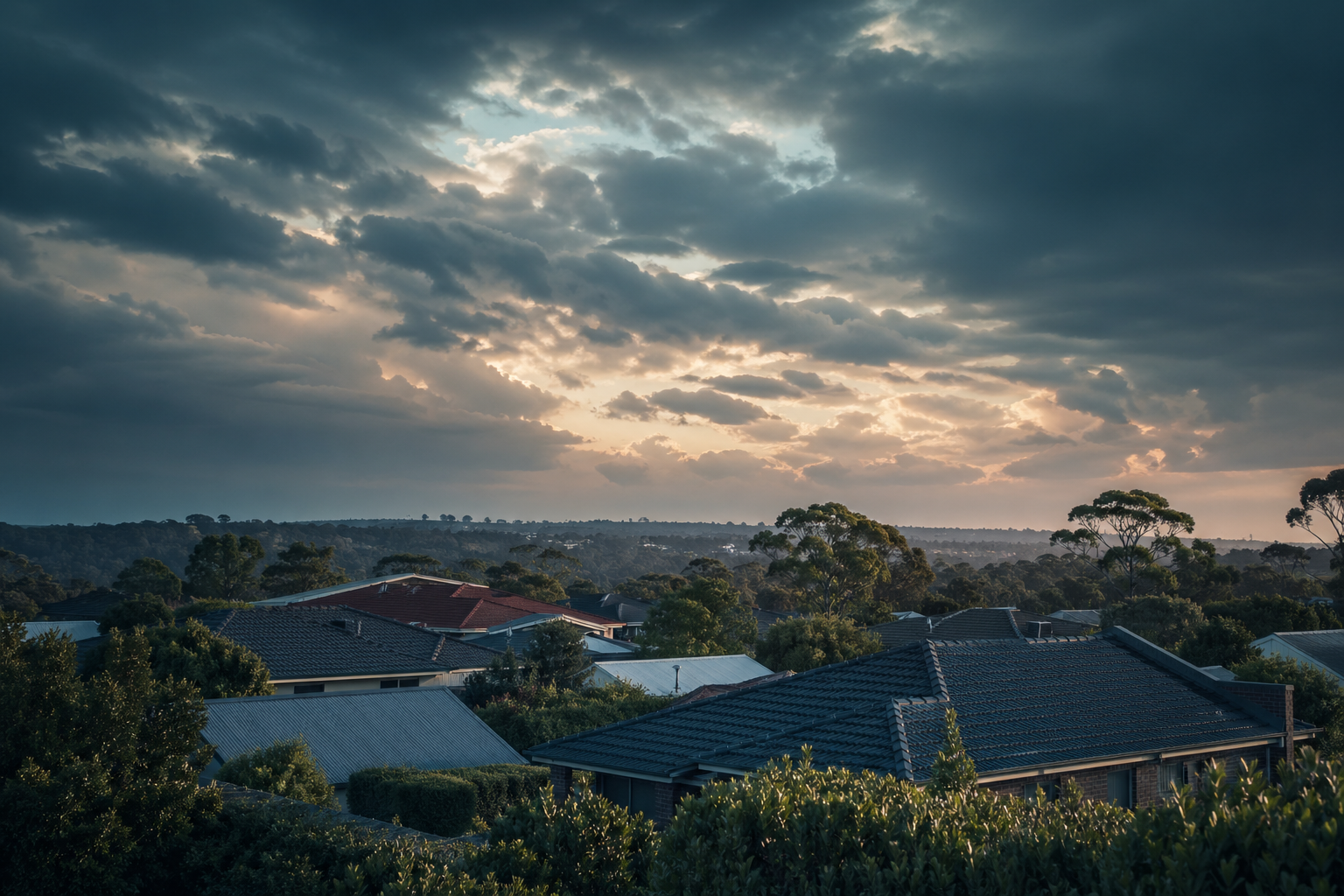 Australian suburban rooftops at dusk under dramatic clouds — editorial image for home insurance and mortgage context